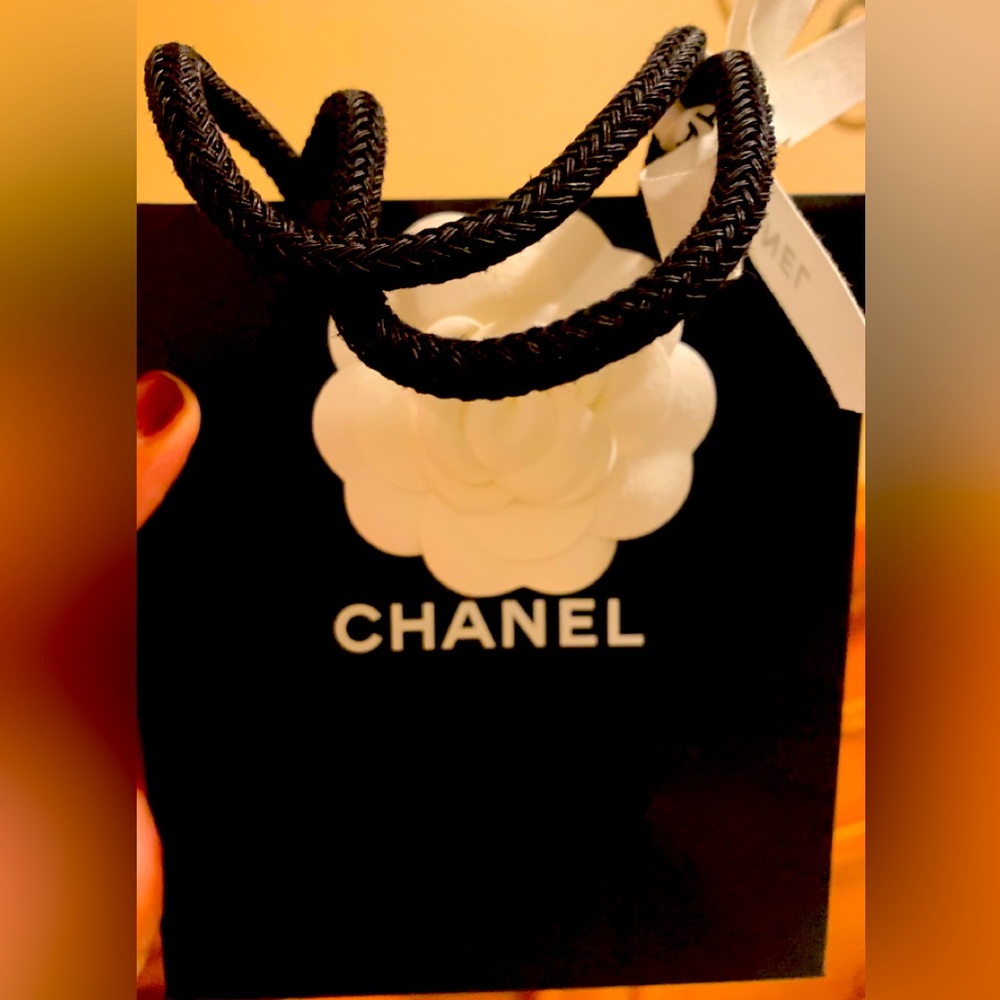 Rare and unique authentic Chanel bag with Chanel print ribbon and flower.